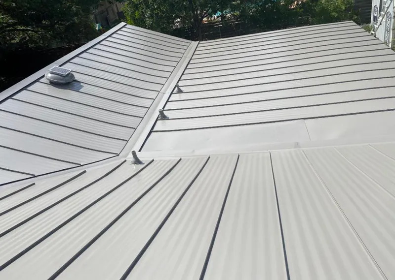 Solar attic fan installed on a metal roof for Roof Ventilation in Mustang
